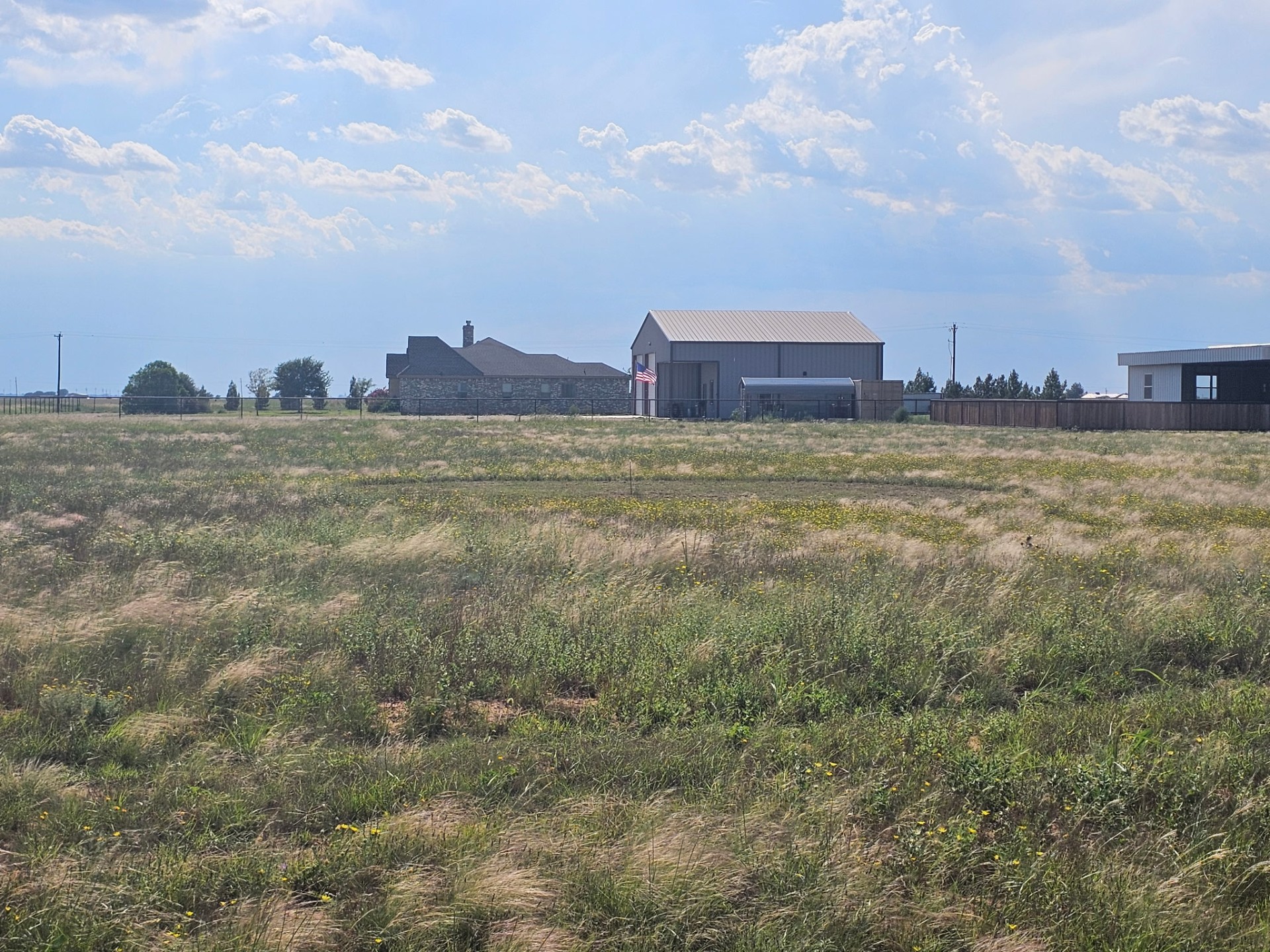 The Boots & Roots Outpost property with barn and house under a wide West Texas sky