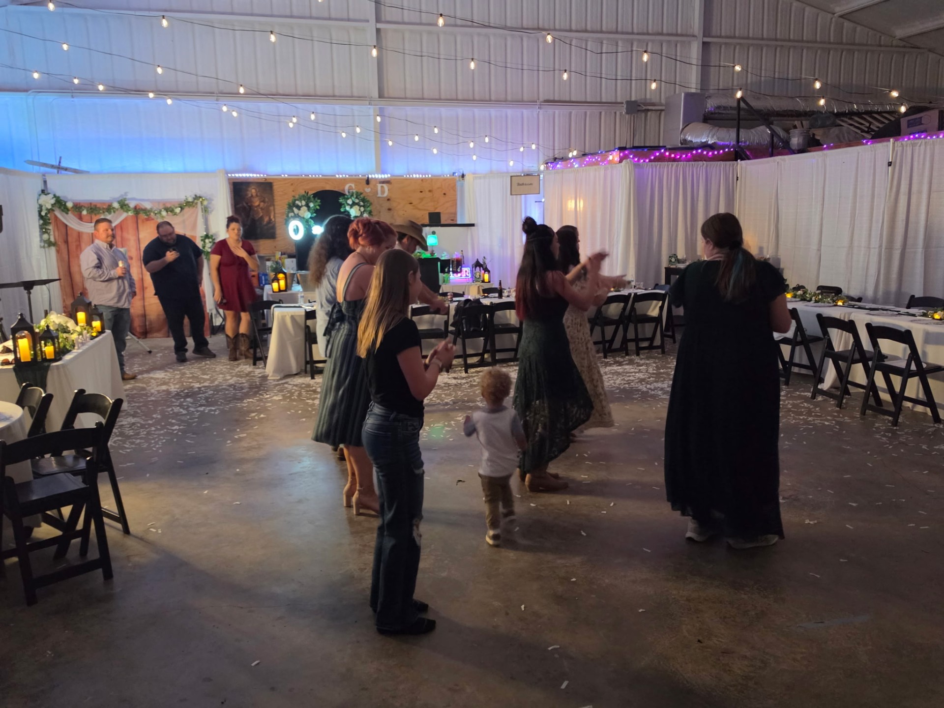 Guests dancing at a reception inside the barn